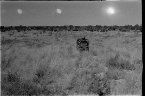 View of the Okwa Omuramba; expedition trucks in distance