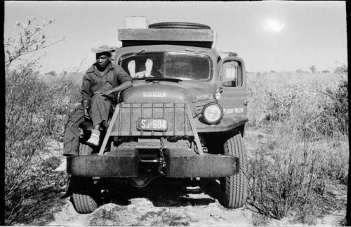 Kernel Ledimo sitting on the front left wheel of the expedition power wagon