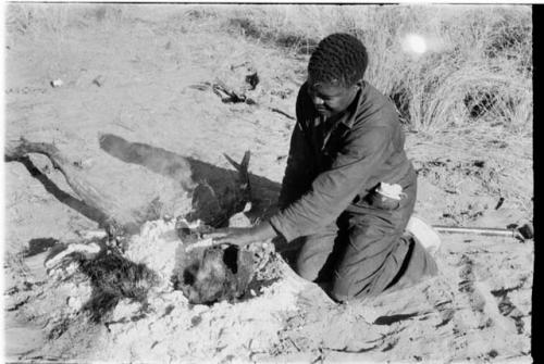 Philip Hameva cooking springbok joint wrapped in a hide