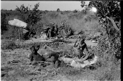 Oukwane, !Gai, and other people sitting beside their fires