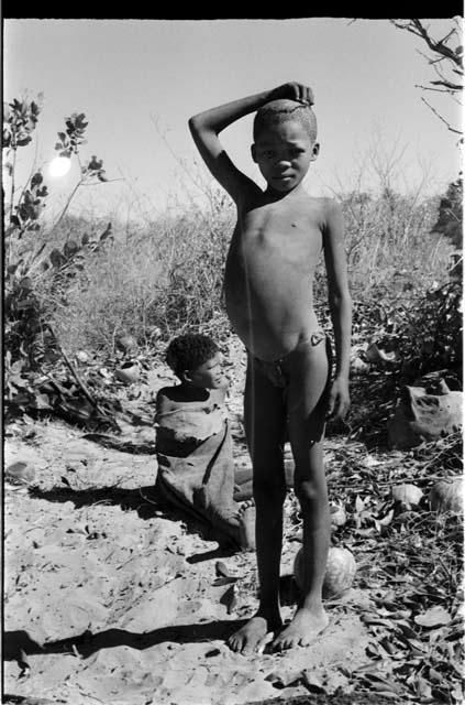 /Gaiamakwe standing and /Kwaiǂkabe sitting behind him