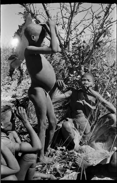 !Oukabe standing, /Twikwe sitting smoking, and two other people sitting