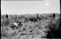 Expedition members standing and filming Oukwane skinning the gemsbok