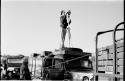 John Marshall with a camera on tripod, on top of expedition truck