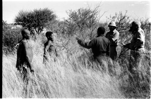 Oukwane and !Gai talking with Dabe, Laurence Marshall, and two other expedition members