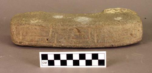 Ground stone fragment, carved design, broken from larger object