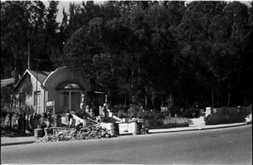 People working in front of building