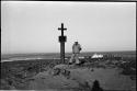 Man standing next to monument on beach