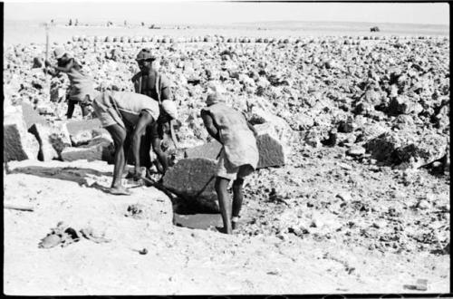 Men moving blocks of salt at Bitters Pan