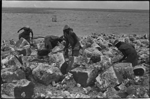 Men breaking up blocks of salt at Bitters Pan