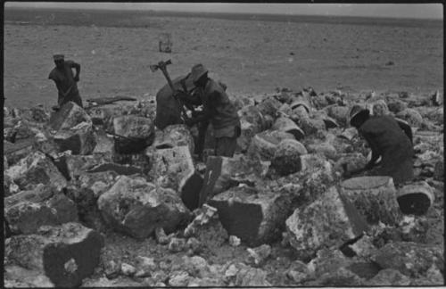 Men breaking up blocks of salt at Bitters Pan