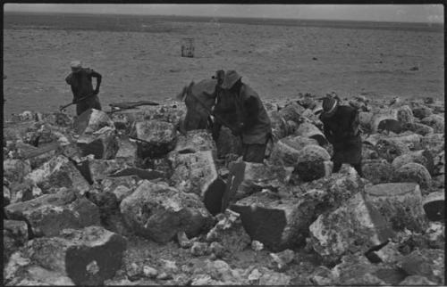 Men breaking up blocks of salt at Bitters Pan