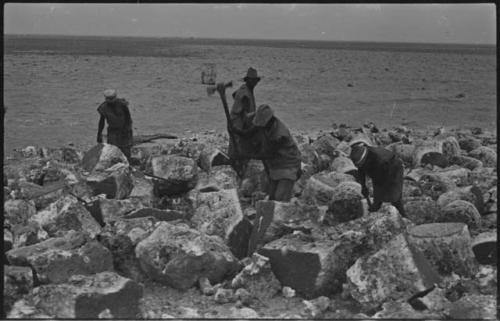 Men breaking up blocks of salt at Bitters Pan