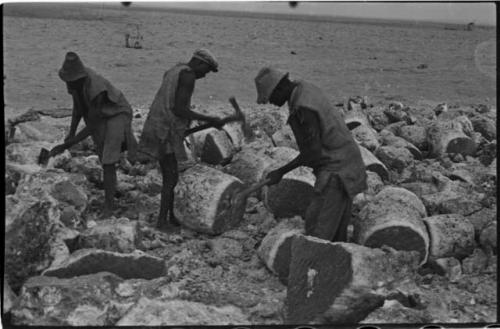 Men breaking up blocks of salt at Bitters Pan