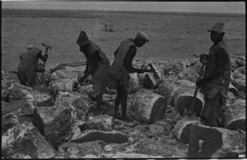 Men breaking up blocks of salt at Bitters Pan