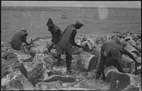 Men breaking up blocks of salt at Bitters Pan