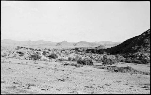 Landscape, with rock structure and hill in distance