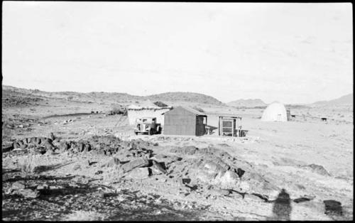 Small building, truck and tents