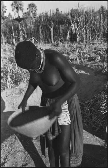 Woman standing and holding a basket