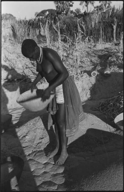 Woman standing and holding a basket