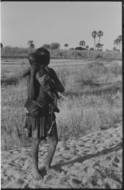 Woman standing and holding a baby