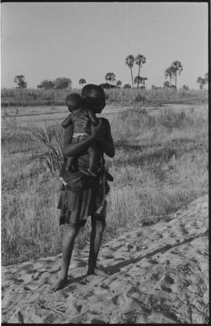 Woman standing and holding a baby