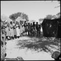 Group of women clapping and singing, being recorded