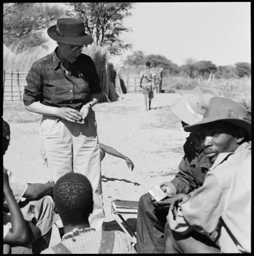 Group of people having their skin color documented, with Lorna Marshall watching