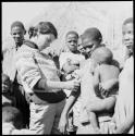 Woman holding a baby and having her skin color documented by Deborah Marshall