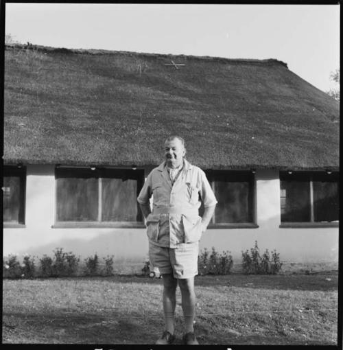 C. J. Mathias standing in front of his house