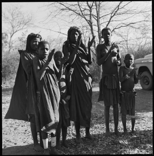 Group of women and children clapping and singing