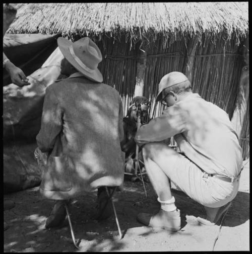 Siamo playing kagoma (musical bow), and being recorded by Kernel Ledimo and Nicholas England