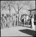 Group of children standing and being photographed by Lorna Marshall