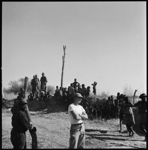 Group of people standing and watching float, including Nicholas England