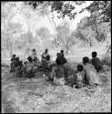 Kernel Ledimo and Lorna Marshall interviewing a group of people sitting on the ground