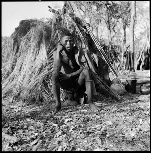 Kumsa sitting by a windbreak