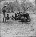 Group of women sitting and singing menstruation songs, with Kernel Ledimo recording them