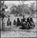 Group of women sitting and singing menstruation songs, with Kernel Ledimo recording them