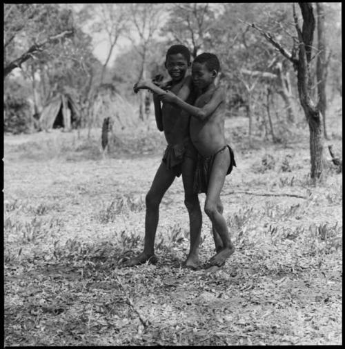 Two girls standing, with their arms around each other