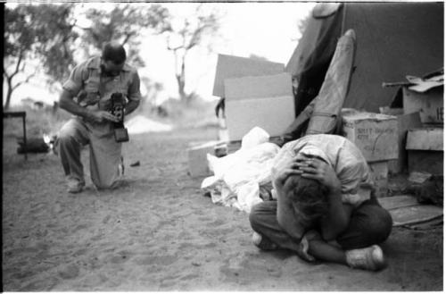 Robert Story taking a picture of Elizabeth Marshall Thomas bent over, hiding her face