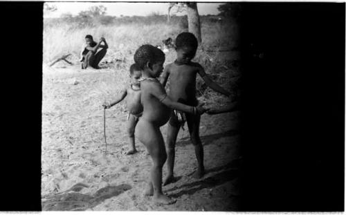 Three boys playing (image partly obscured)