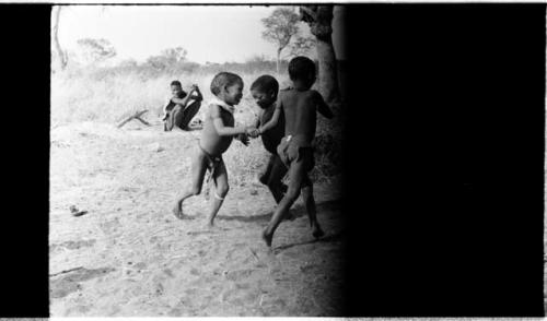 Three boys playing (image partly obscured)