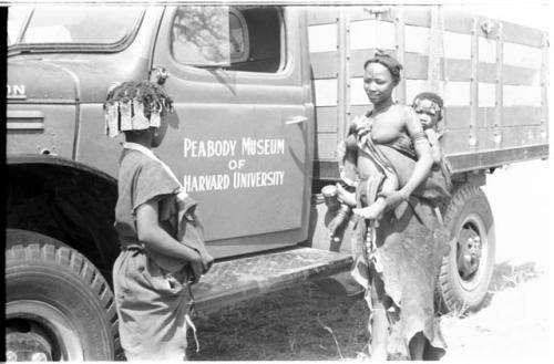 N!ai and a woman in front of the expedition Dodge showing "Peabody Museum of Harvard University" on the door