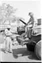 Casper Kruger sitting on hood of GMC truck, with Robert Story standing