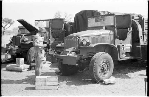 Casper Kruger standing beside the two GMC trucks