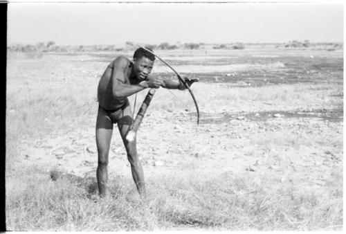 "Crooked /Qui" demonstrating shooting an arrow