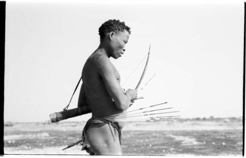 Side view of "Crooked /Qui" showing six arrows in place ready to be pulled out of his belt, half figure standing