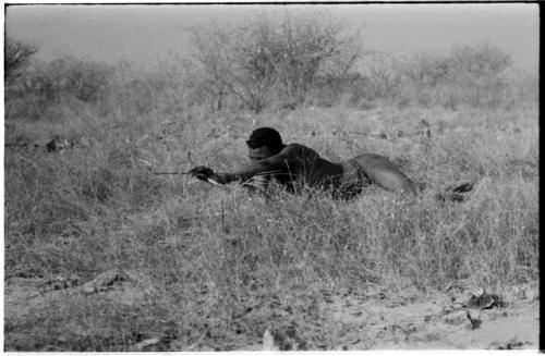 "Crooked /Qui" lying in grass in shooting position