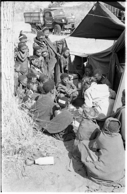 Group of Ju/'hoansi, Kernel Ledimo, Lorna Marshall gathered around to look at beads