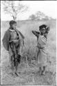 "Visiting girl" and a younger girl standing, with a cloth wrapped around herself as a garment